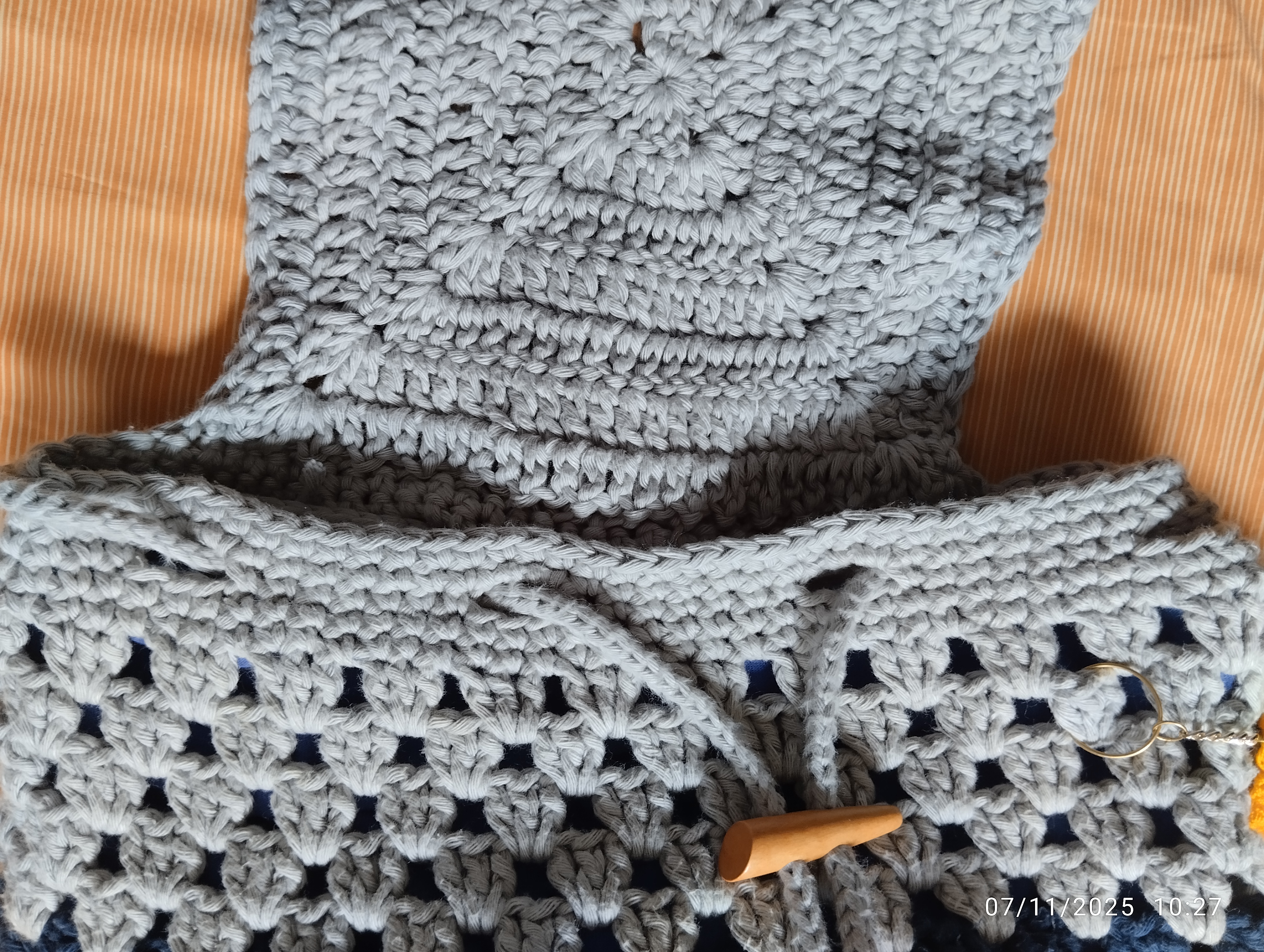 close up to open flap showing strap that closes the bag